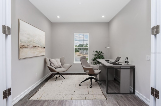 home office with dark hardwood / wood-style floors