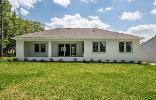 back of house featuring a lawn