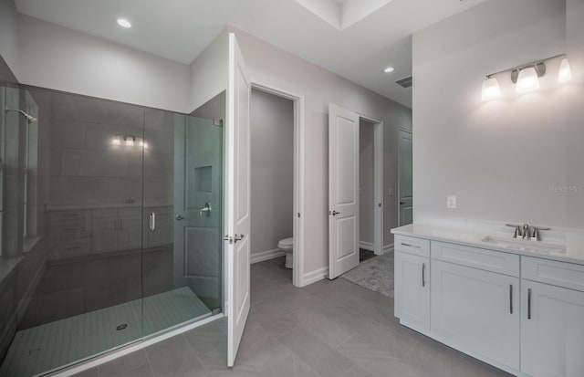 bathroom with toilet, vanity, an enclosed shower, and tile patterned floors