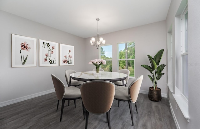 dining space with dark hardwood / wood-style floors and a chandelier