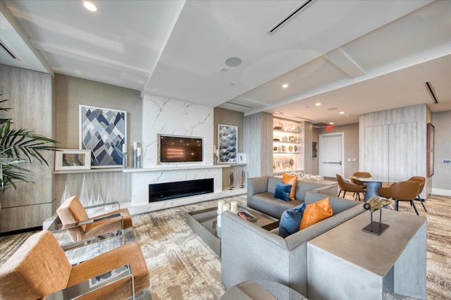 living room with built in shelves and a premium fireplace