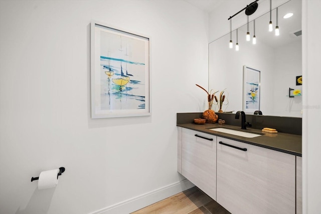 100 1st Ave N Unit 1601, Saint Petersburg, FL 33701 - bathroom featuring vanity, baseboards, and wood finished floors