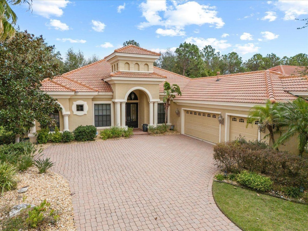 mediterranean / spanish house featuring a garage