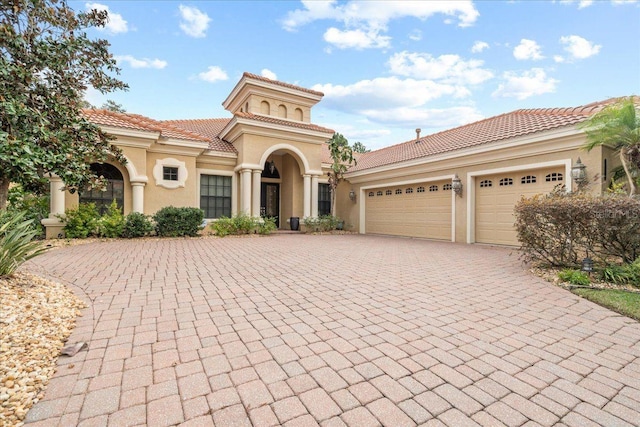 mediterranean / spanish home with a garage