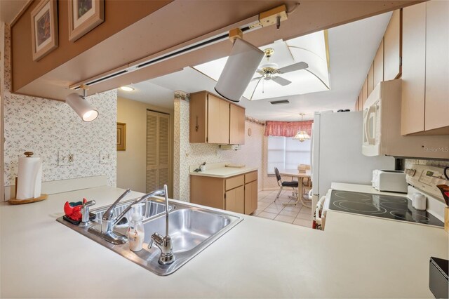 kitchen with ceiling fan, sink, kitchen peninsula, white appliances, and light tile patterned flooring