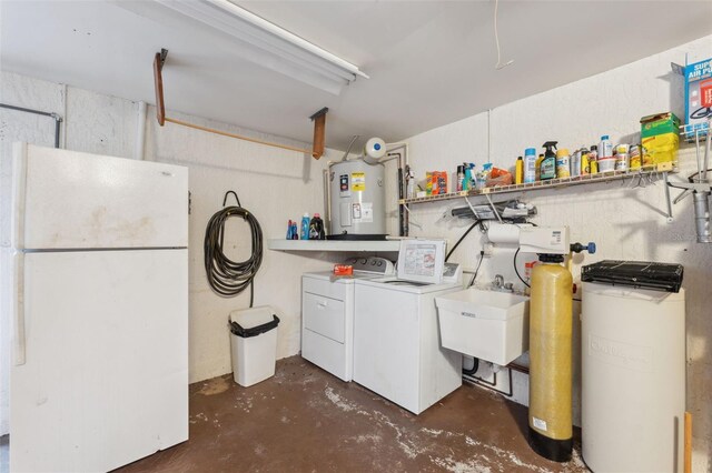 washroom featuring washing machine and dryer, electric water heater, and sink