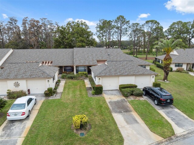 view of front facade with a front yard and a garage