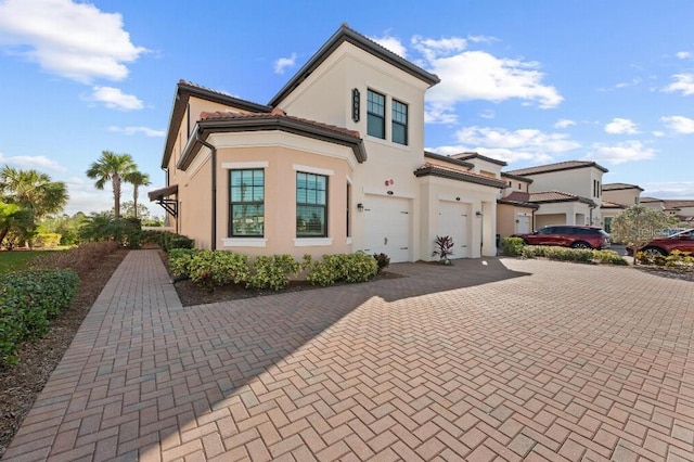 back of property featuring a garage