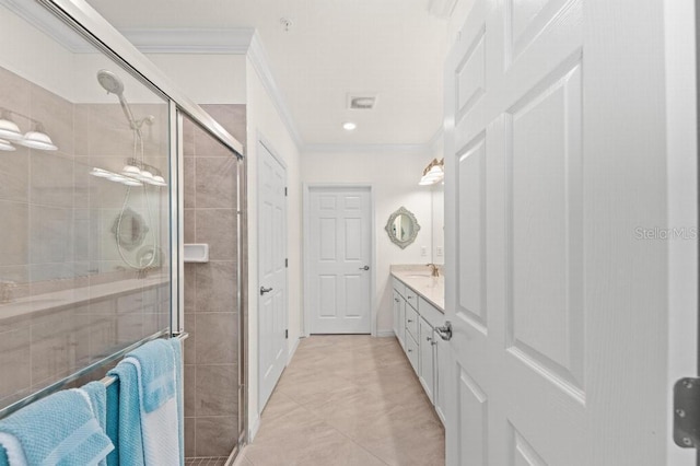 bathroom featuring vanity, tile patterned floors, walk in shower, and crown molding