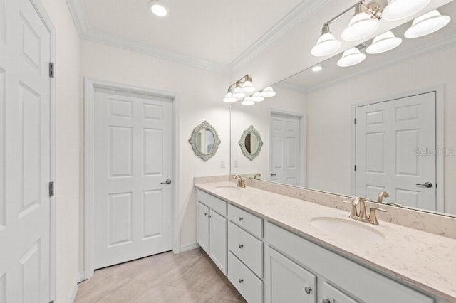 bathroom featuring crown molding and vanity