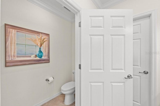 bathroom featuring tile patterned floors, ornamental molding, and toilet