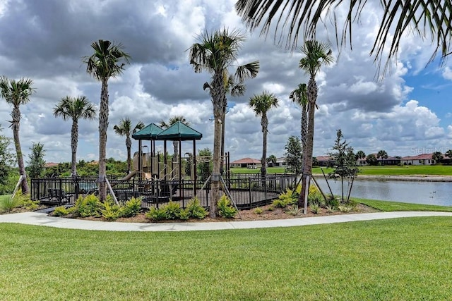 view of play area featuring a water view and a lawn