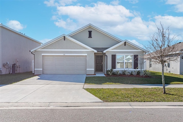 view of front facade with a front yard and a garage