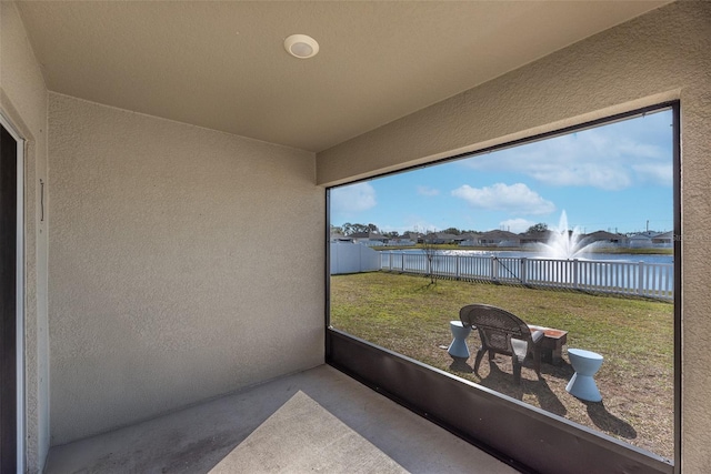 sunroom / solarium with a water view