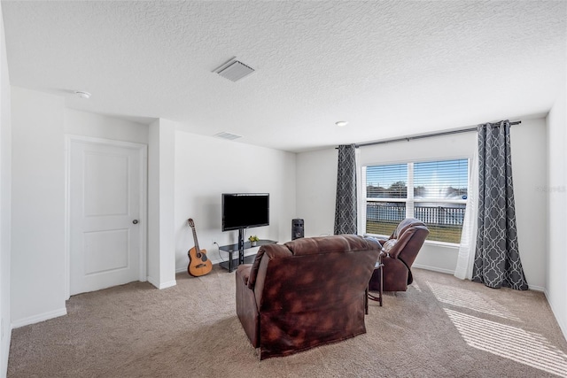 living room featuring light carpet and a textured ceiling