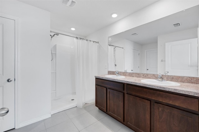 bathroom featuring tile patterned floors, vanity, and walk in shower