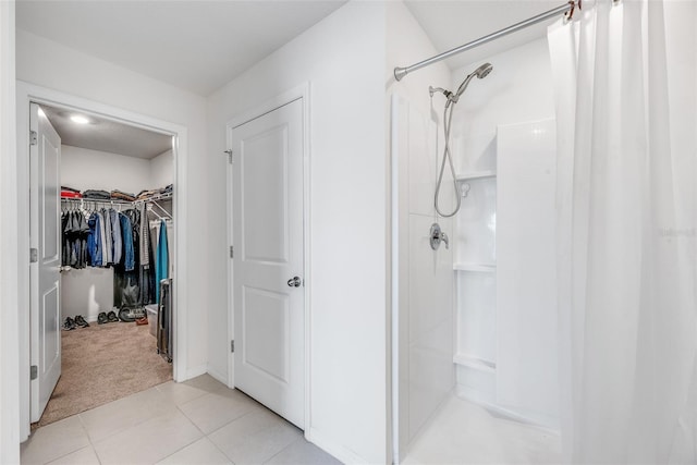 bathroom featuring tile patterned flooring and walk in shower