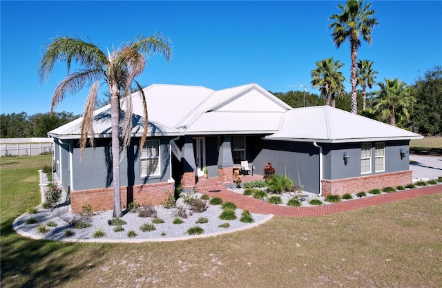 view of front of home with covered porch and a front yard