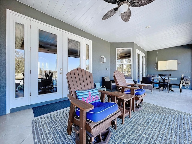 sunroom featuring ceiling fan and french doors