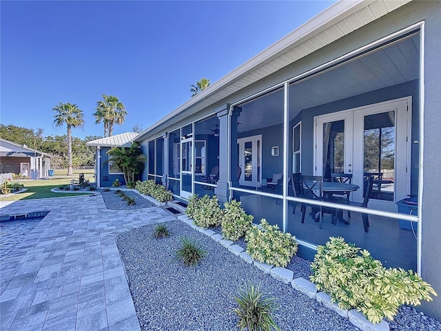 view of side of property with a patio area and ceiling fan