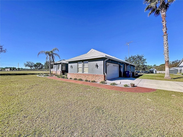 view of front of house featuring a garage and a front lawn