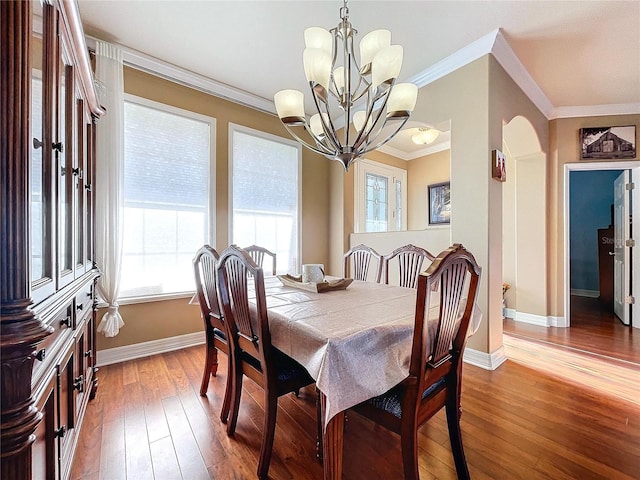 dining area featuring a chandelier, hardwood / wood-style flooring, and crown molding