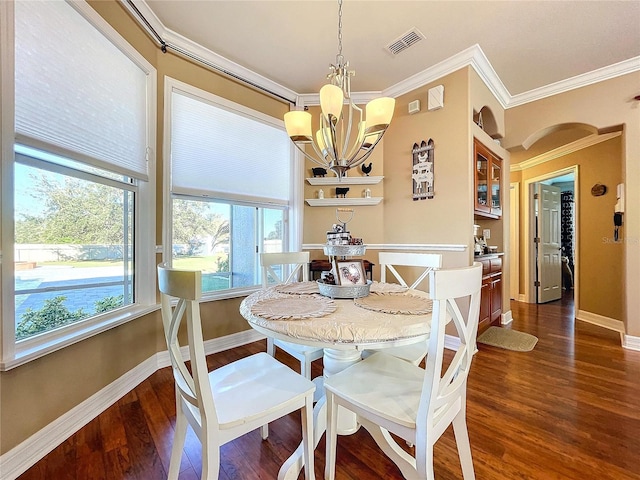 dining room with crown molding, plenty of natural light, and dark wood-type flooring