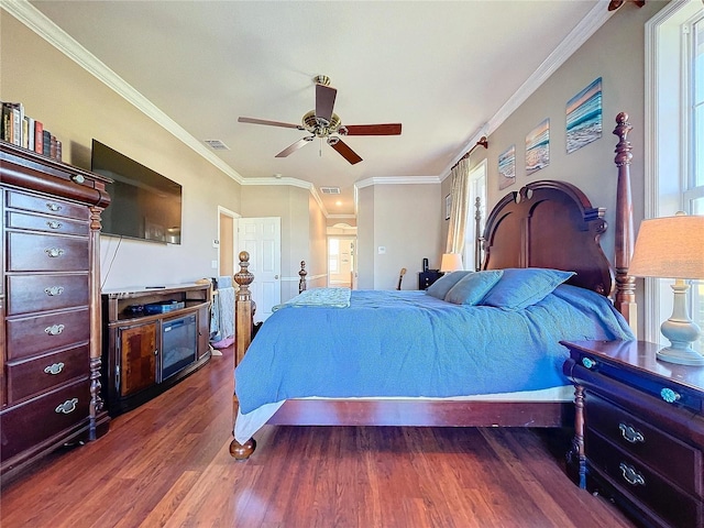 bedroom with multiple windows, ceiling fan, crown molding, and dark hardwood / wood-style floors