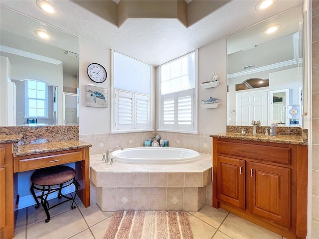 bathroom with a wealth of natural light, tile patterned flooring, vanity, and shower with separate bathtub