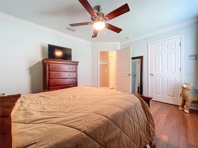 bedroom featuring ceiling fan, dark wood-type flooring, and ornamental molding