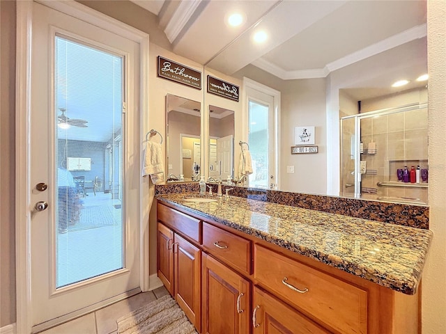 bathroom with tile patterned floors, crown molding, vanity, and an enclosed shower