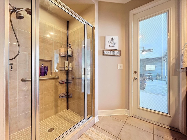 bathroom featuring tile patterned floors, ceiling fan, and a shower with shower door