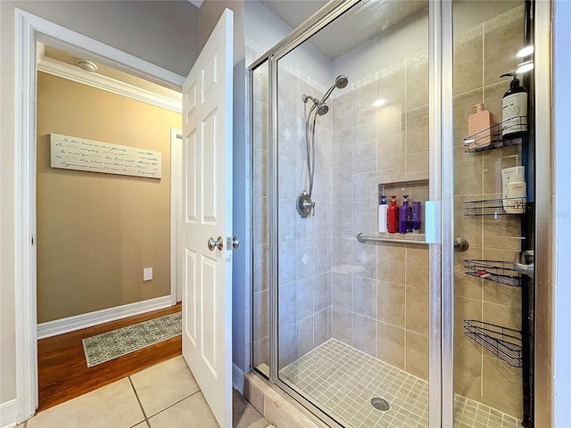 bathroom with tile patterned flooring and a shower with door