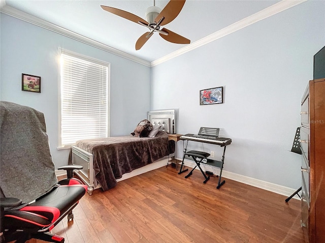 bedroom featuring multiple windows, hardwood / wood-style flooring, ceiling fan, and ornamental molding