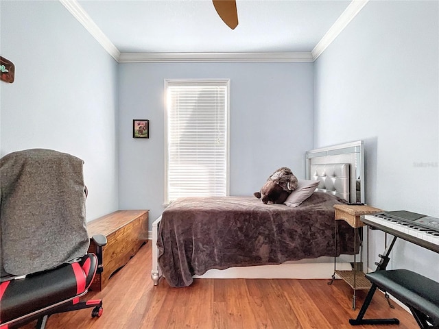 bedroom with hardwood / wood-style flooring, ceiling fan, and ornamental molding