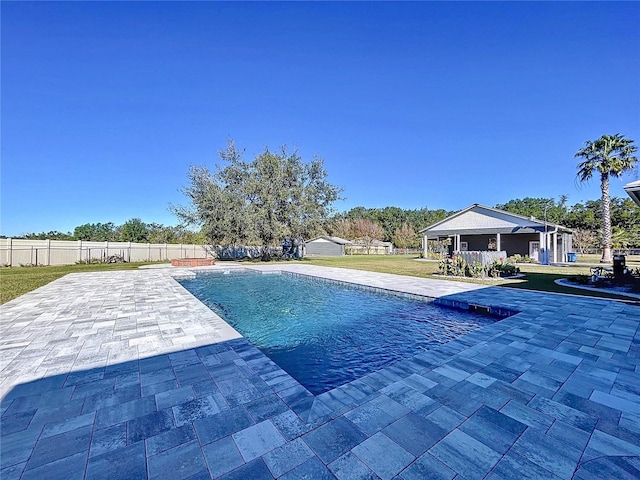 view of swimming pool with a patio and a lawn