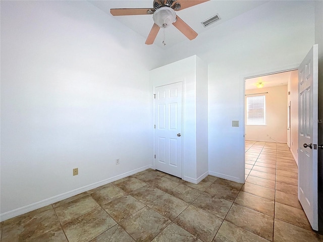 unfurnished bedroom with ceiling fan and a closet