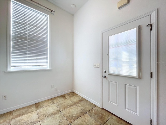 entryway with light tile patterned flooring