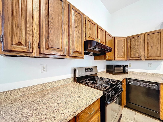 kitchen with light tile patterned floors, black dishwasher, and gas range