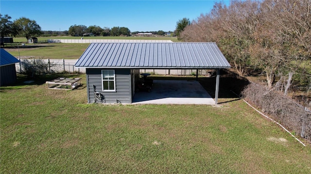 view of outbuilding with a yard and a carport