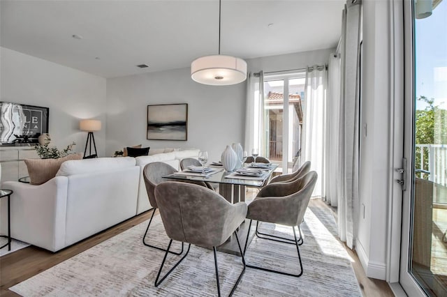 dining space with visible vents and light wood-style floors