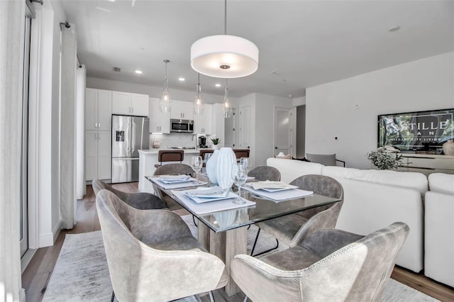 dining space with wood finished floors, visible vents, and recessed lighting