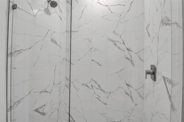 full bath featuring a marble finish shower