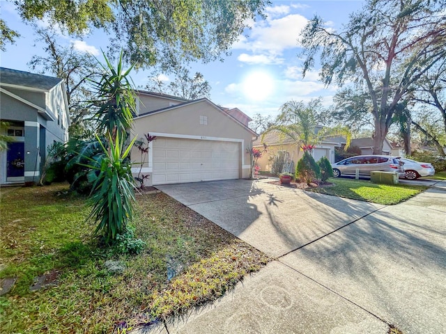 view of front of home with a front yard and a garage