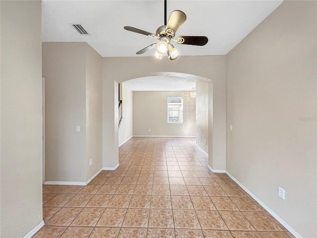 spare room featuring ceiling fan and light tile patterned flooring