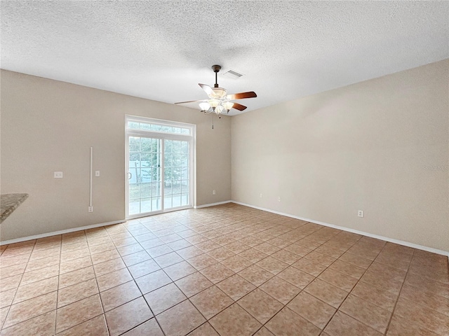 unfurnished room with light tile patterned floors, a textured ceiling, and ceiling fan