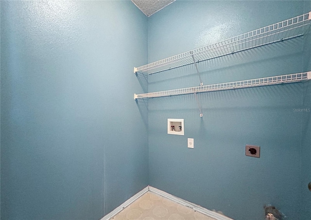 washroom featuring hookup for an electric dryer, washer hookup, a textured ceiling, and gas dryer hookup