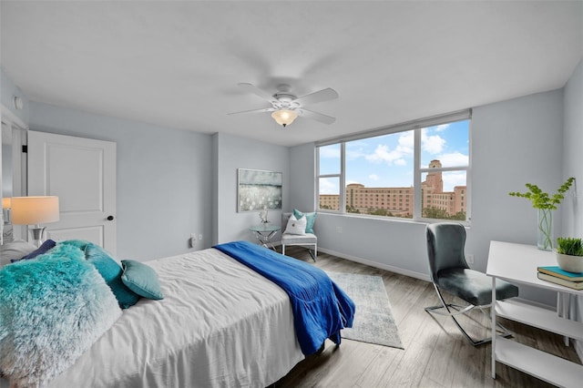 bedroom with ceiling fan and wood-type flooring