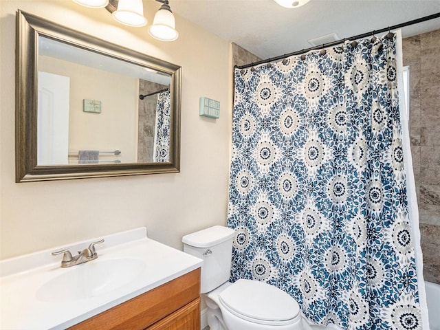 bathroom with vanity, toilet, and walk in shower