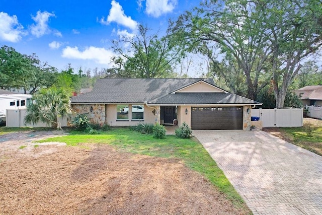 ranch-style home with a front lawn and a garage